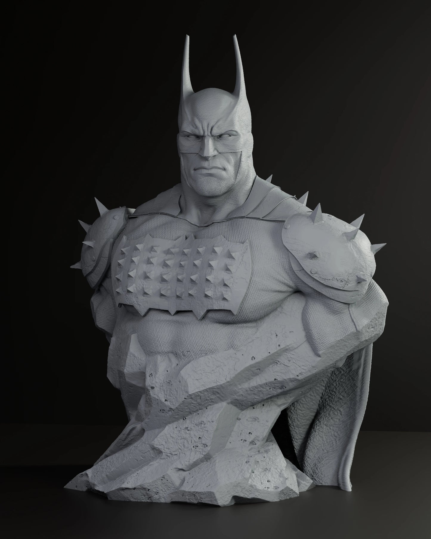 Grey bust of Batman with spiked shoulder armor and detailed rocky base, scowling forward.