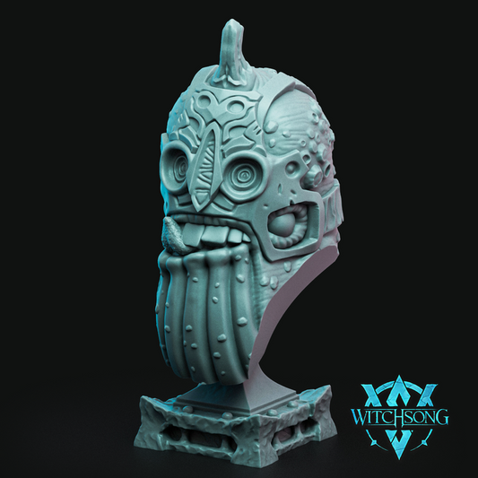 Bust of Treachery of Whales showing a grotesque aquatic helmet with barnacles, tusks, and tongue sticking out, mounted on a coral-textured base.