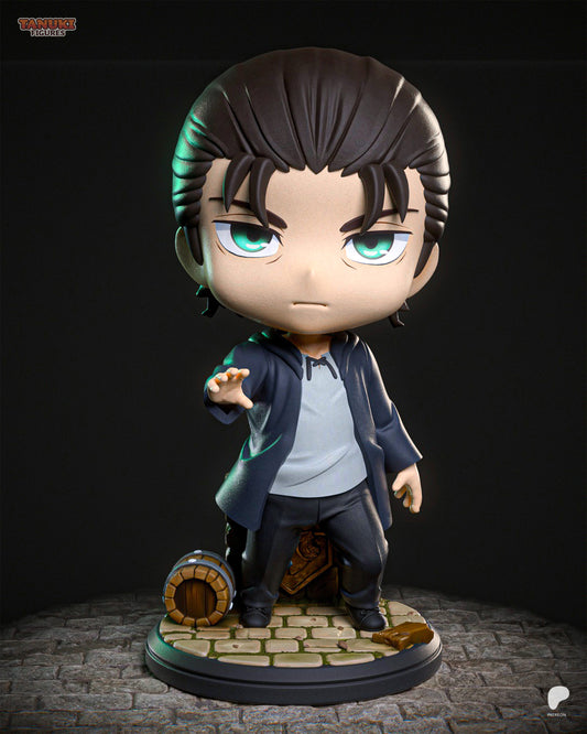 Full view of chibi Eren figurine standing with hand extended, on a cobblestone base with a barrel and wooden crate.