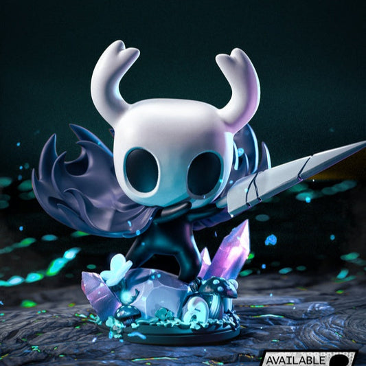 Chibi Hollow Knight figurine rear view showing horned head, flowing black cloak, and detailed crystal base with glowing mushrooms.