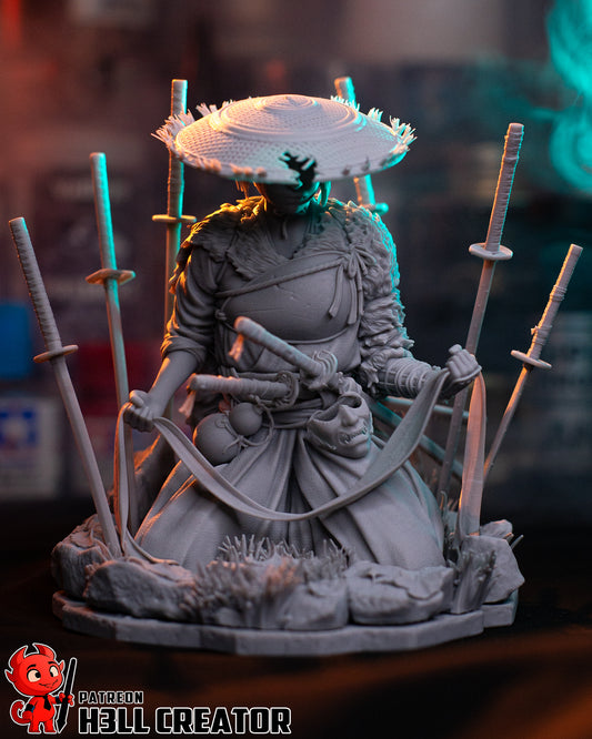 Front view of unpainted Atsu figure kneeling with hands holding banner and multiple swords behind.