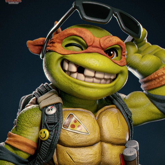 Close-up of Michelangelo’s face winking with big grin, holding sunglasses, showing chest pizza slice emblem, orange bandana, and detailed backpack straps.