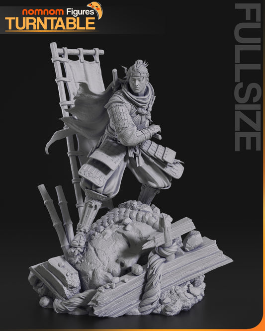 A grayscale 1:10 scale model of Jin Sakai standing atop a battlefield base, gripping his katana.