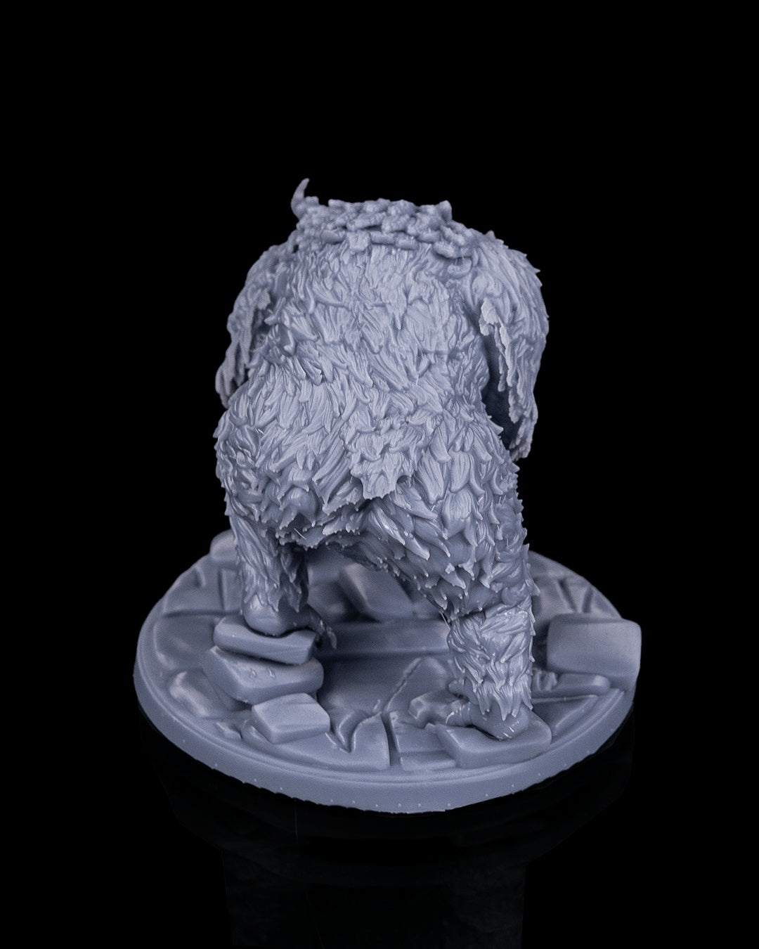 Owlbear miniature rear view from Beldrad's Bag of Beasts showing layered feathers, muscular limbs, taloned feet, and low stalking posture, avian ogre monstrosity for tabletop roleplaying games