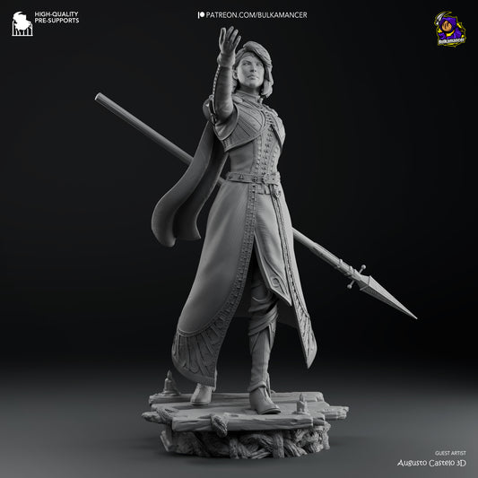 A grayscale render of Isobel in a confident pose, standing on an ornate base, with detailed armor and flowing garments.