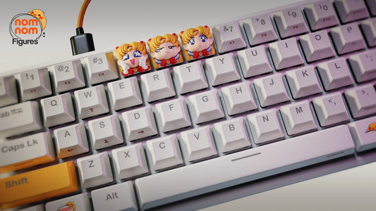 Wide-angle image showing the keyboard setup with all three Sailor Moon keycaps placed between standard keys.
