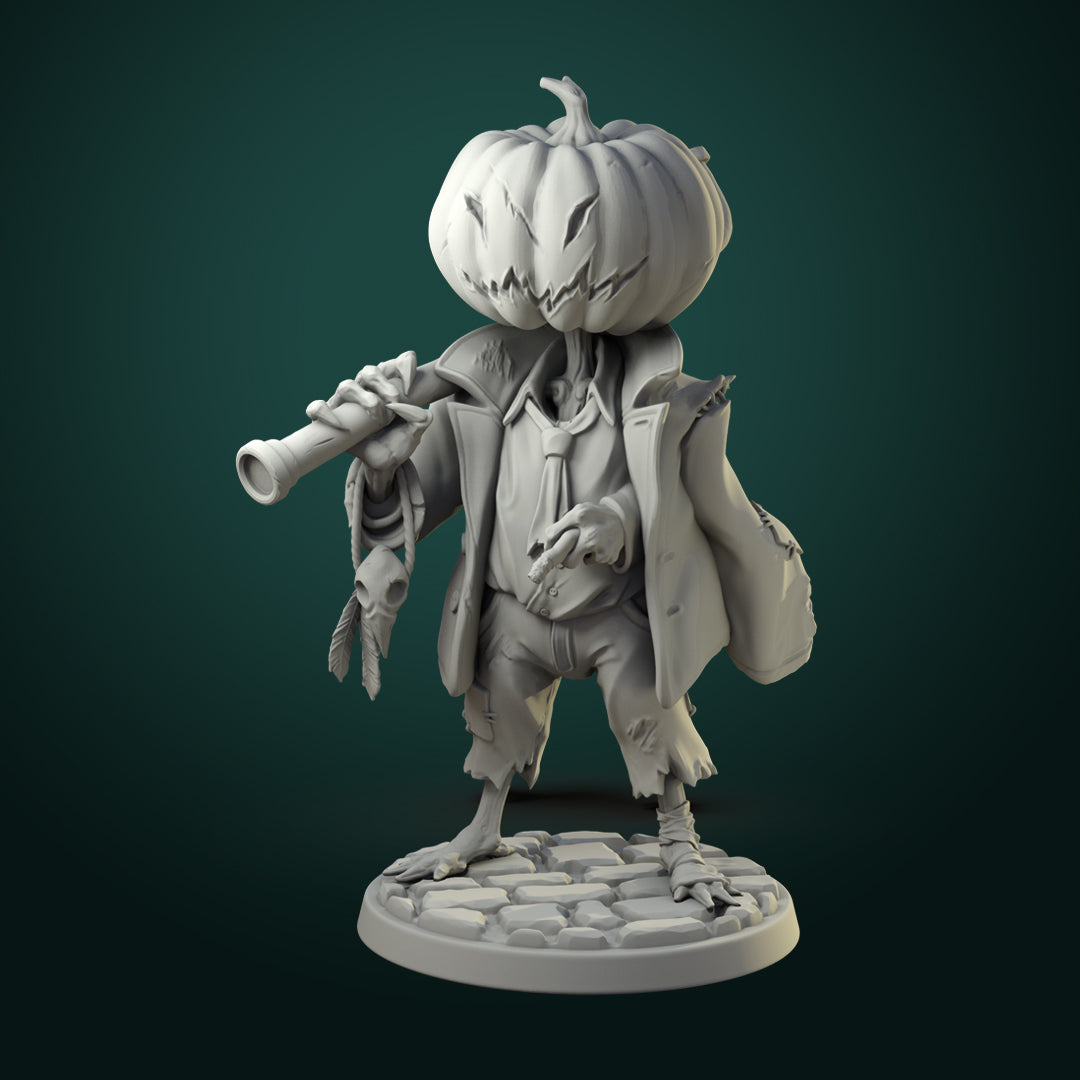 Scarecrow miniature with carved pumpkin head, tattered coat, and twisted staff standing on cobblestone base.