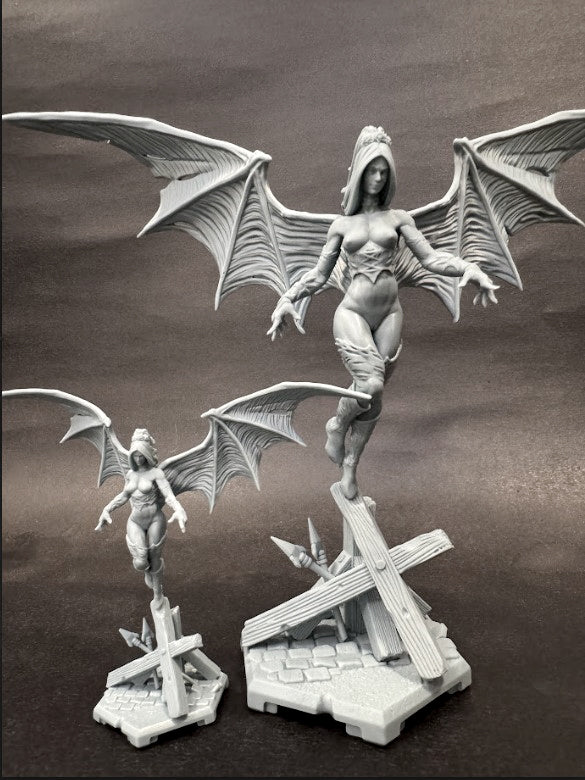 Fully assembled succubus miniature with wings extended and standing on a debris base, displayed in two size variants.