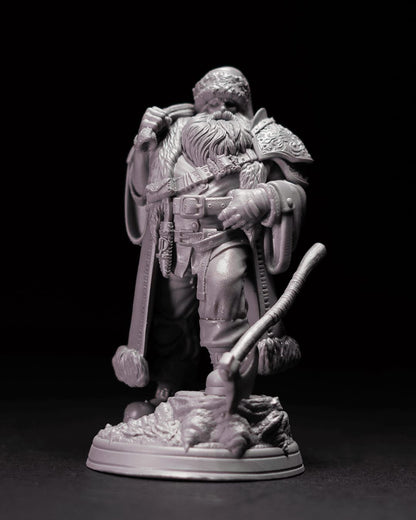 Big Daddy miniature depicting a bearded warrior in a detailed fur-lined cloak, holding a pipe with one hand, dressed in rugged attire with a belt and pouches, standing on a textured base.