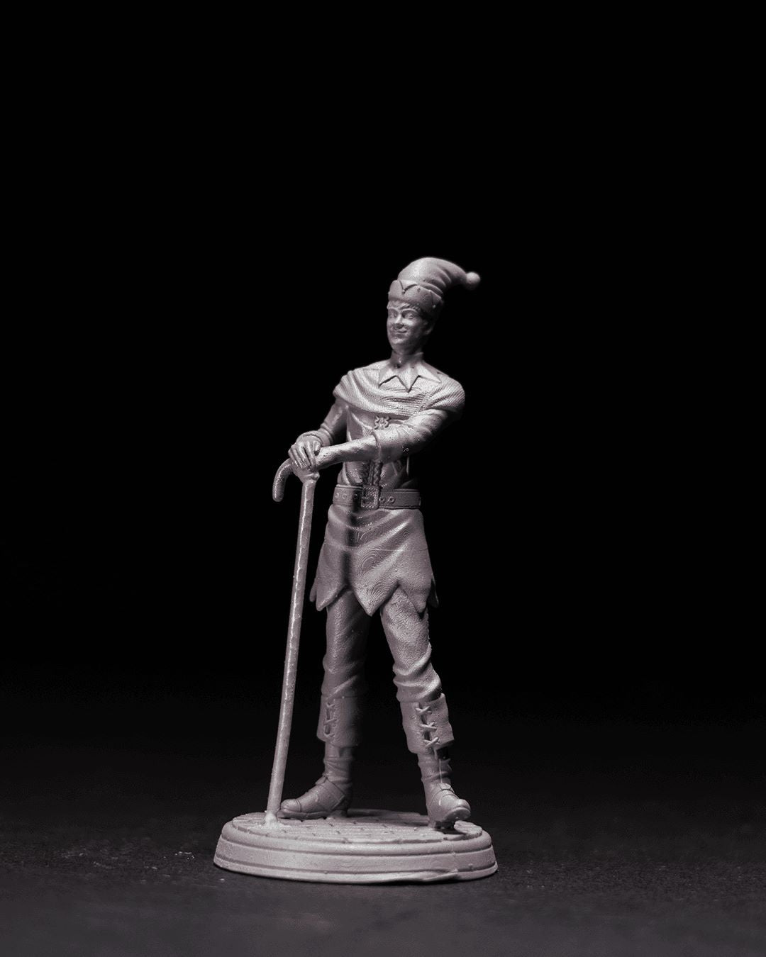 Floki the Elf miniature depicted standing with a candy cane staff, wearing a festive hat and detailed elf attire, with a playful expression, positioned on a circular base.