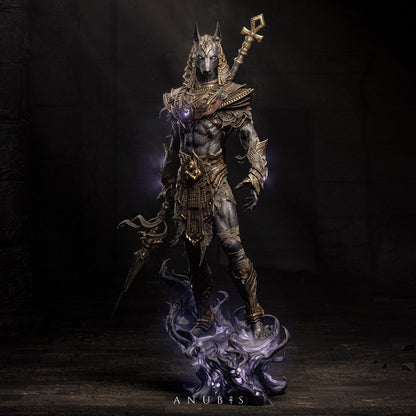 Full view of Anubis figurine standing in detailed armor, holding a staff, surrounded by dark energy effects.