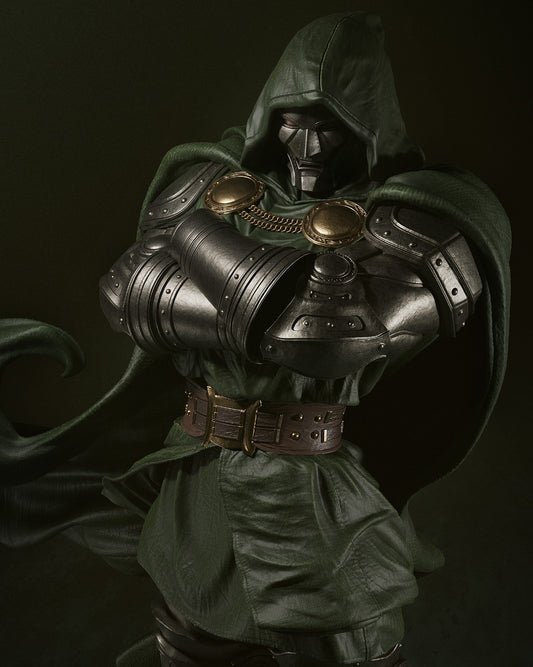 Front view of Dr. Doom figurine in a powerful stance, with arms crossed and detailed chest armor, green cloak flowing around him.