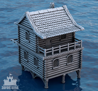 Front view of the 3D-printed medieval village house with two stories, log walls, and a waterfront platform.