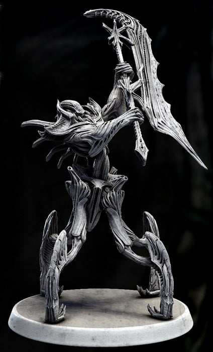  alien-like figure posed with a sword held above its head, standing on a 50mm base, with a biomechanical design reminiscent of H.R. Giger’s style.