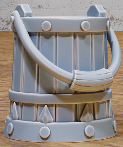 Fantasy dungeon bucket with tall handle and engraved metal banding for use as scatter terrain in Dungeons & Dragons or Pathfinder