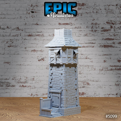 Stone prison watch tower miniature with brick blockwork, heavy door, and rooftop battlements; 3D‑printed tabletop terrain by Epic Miniatures.
