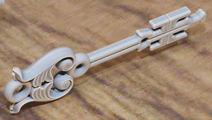 Key with gear‑shaped bow and faceted gem center.
