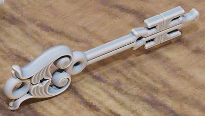 Key with gear‑shaped bow and faceted gem center.