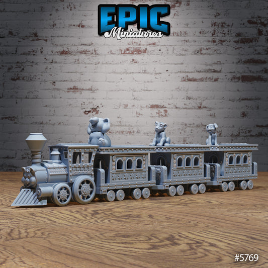 Train Ride miniature scatter terrain featuring a detailed circus train with a smiling engine and animal figures on top of passenger cars, designed with ornate star patterns and riveted panels on a wooden surface.
