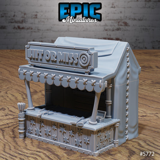 Bullseye miniature depicting a carnival shooting gallery booth with target sign, canopy, and star-decorated counter for fantasy terrain.