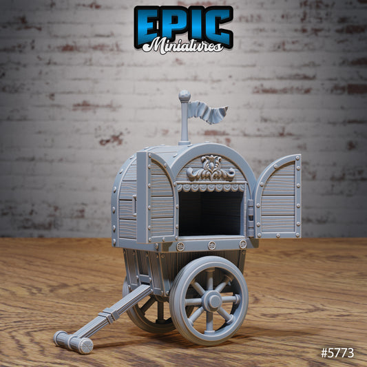 Mobile Theater Cart miniature scatter terrain showing an empty puppet stage wagon with open wooden doors, carved trim, and a flag on top, designed for carnival or fairground display.