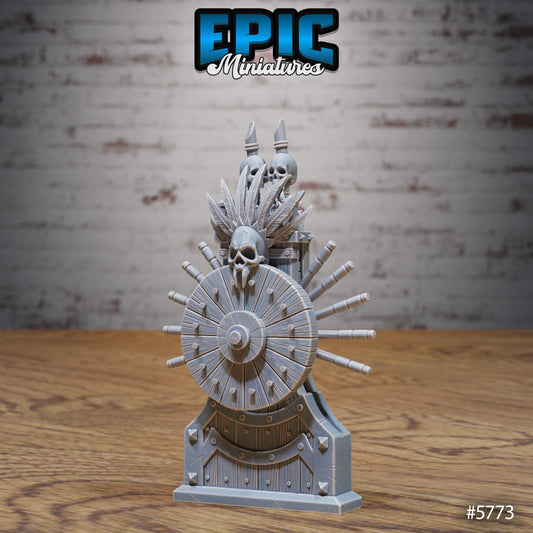 Dark Wheel of Fortune miniature scatter terrain showing a wooden wheel adorned with skulls, spikes, and bone-like decorations mounted on a gothic stand.