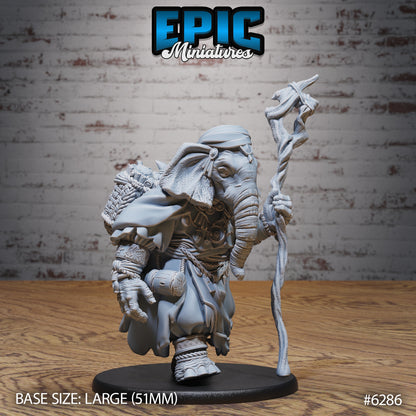 Loxodon druid miniature walking pose holding carved wooden staff robed elephant folk spellcaster Dungeons and Dragons resin tabletop miniature large base