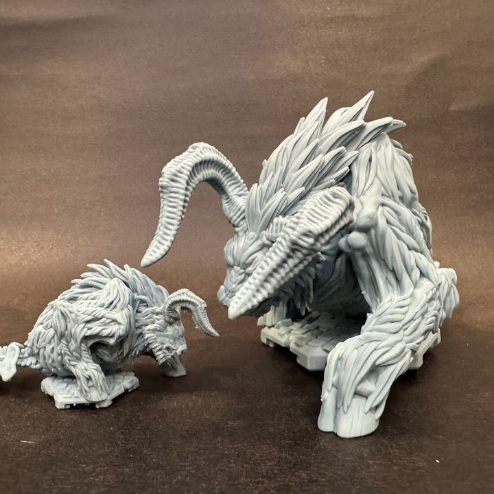 Side-by-side comparison of two Bullhemoth miniatures, highlighting their intricate sculpting details.