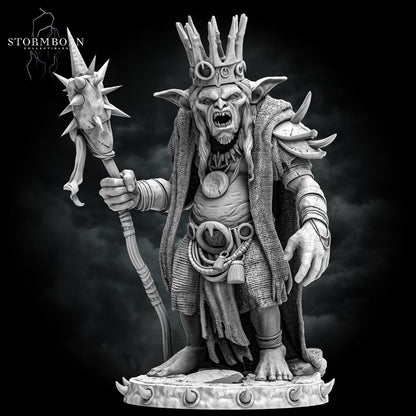 The Goblin King, a menacing goblin leader wearing tattered robes, adorned with a crown of bones, and holding a spiked staff, depicted in a highly detailed miniature for fantasy tabletop RPGs.