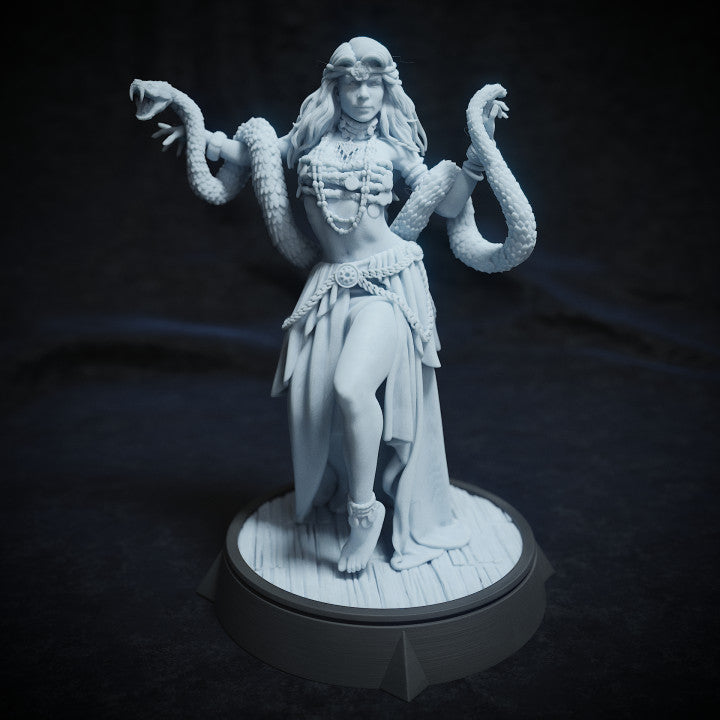 Alma Slyden miniature with flowing robes, adorned in jewelry, posed gracefully while holding a large snake, perfect for a fantasy TTRPG setting.