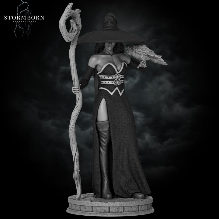 A striking miniature of Azora the Witch, featuring a female spellcaster in a long, flowing black dress with a high slit. She holds a gnarled staff in one hand and a raven perched on her other arm. Her wide-brimmed hat and confident stance add an aura of mystique and power.