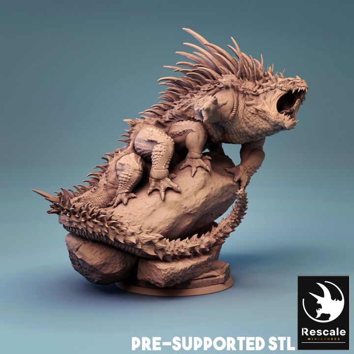 Basilisk miniature depicted as a spiked, reptilian creature perched on a rocky base, with scales and an open, snarling mouth, ready to petrify any adventurer that crosses its path.