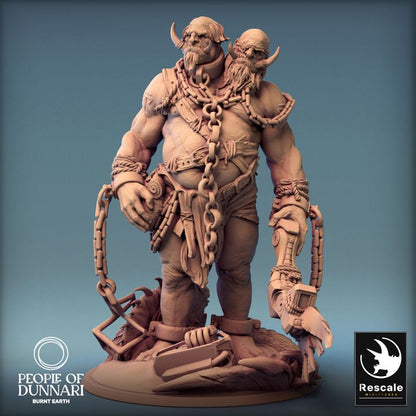 Sand Ettin standing still, with mechanical arm and chains, showing both heads with contrasting expressions.