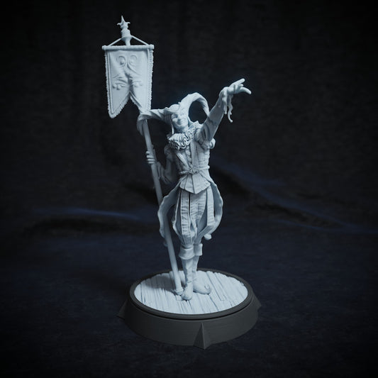 Mr. Kite miniature, dressed as a circus jester with a ruffled collar, holding a banner staff in one hand and gesturing playfully with the other, adding whimsical mischief to a TTRPG setting.