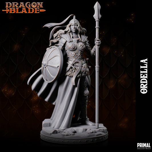 Ordella miniature, an Elf Paladin standing confidently with a spear and shield, wearing detailed armor and a flowing cape.