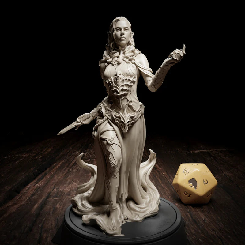 Maude Lacroix figurine standing in a commanding pose, with intricate armor, a dagger in her right hand, and her left arm raised as if casting a spell.