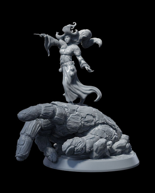 Agatha Penistone standing atop an earth elemental hand, pointing forward in flowing robes.