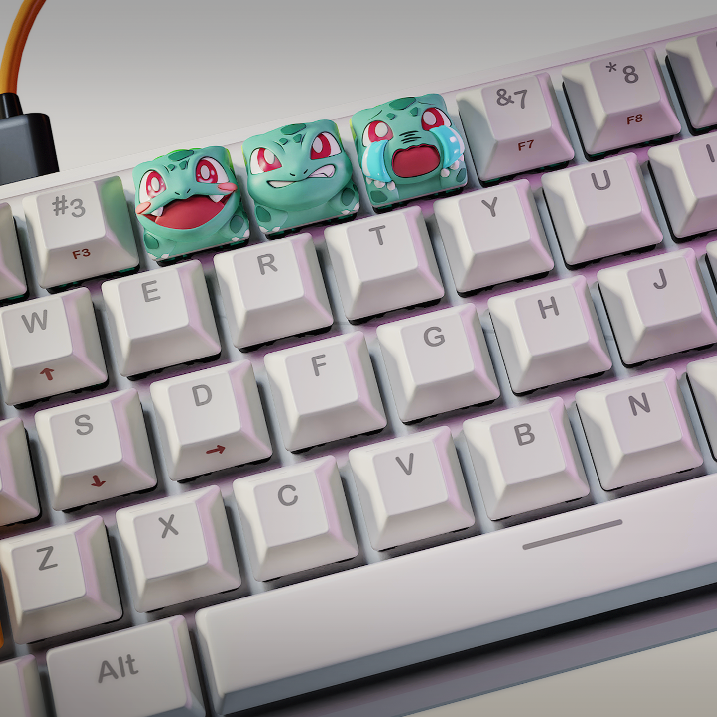 Wide shot of full mechanical keyboard with three Bulbasaur artisan keycaps in top row