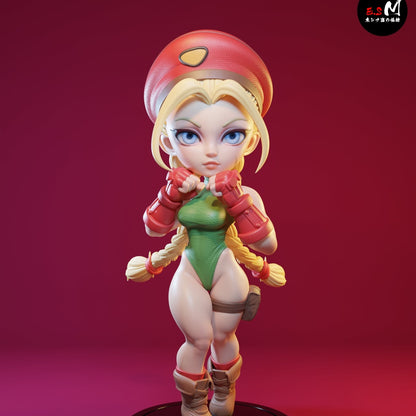 Fully colored render of Chibi Cammy figure in fighting stance with fists raised, wearing beret, leotard, and boots on a round base.