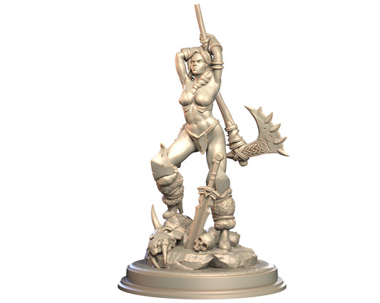 Drazha female human barbarian miniature standing with axe raised and sword planted on rocky base with skulls.
