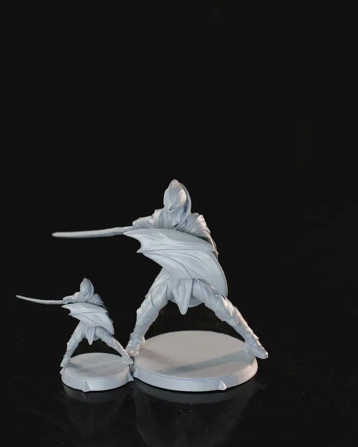 Elven Soldier standing with sword and shield, shown in both 32mm and 75mm versions.