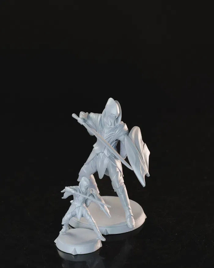 Elven Soldier in a defensive stance with sword and shield, shown in both 32mm and 75mm versions.