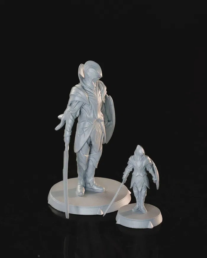 Elven Soldier wielding a sword with a sweeping cloak, shown in both 32mm and 75mm versions.