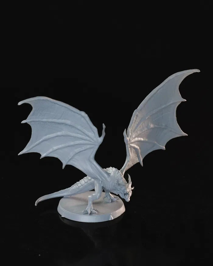 A miniature dragon with outstretched wings, standing on a small base.