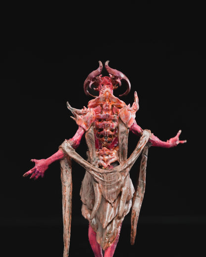 Close-up of the back of the painted Vecna-inspired miniature, highlighting the exposed spine, decaying flesh, and detailed fabric draping.