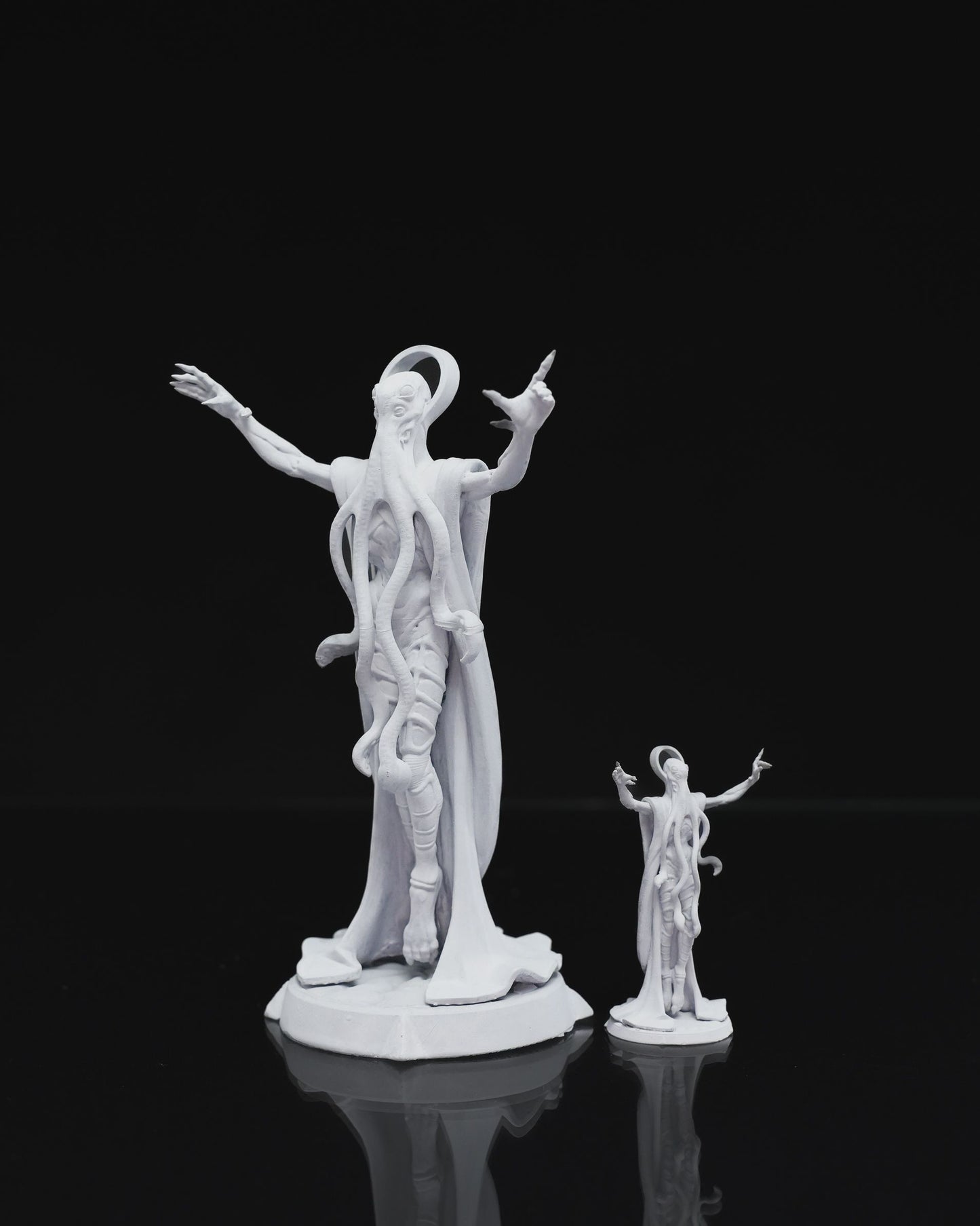 Mind Flayer miniature with outstretched arms, tentacled face, and flowing robes, posed dramatically on a round base.