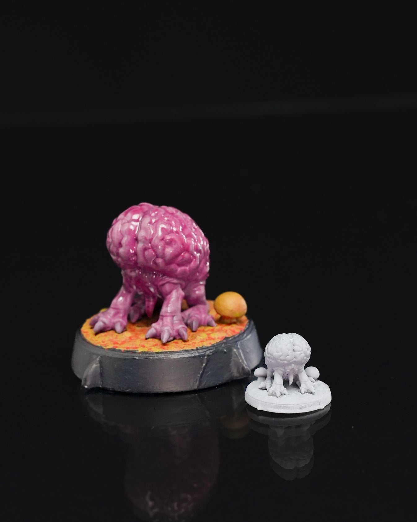 Intellect Devourer miniature with a brain-like body and clawed limbs, standing on a textured base with a small mushroom detail.