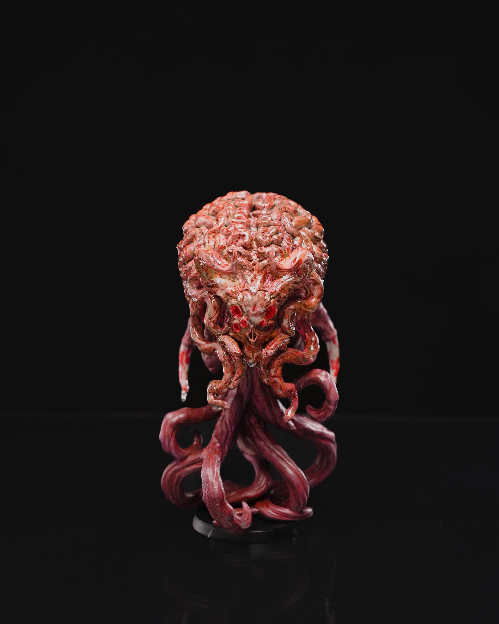 Elder Brain miniature depicting a menacing brain-like entity with multiple tentacles extending outward, featuring a detailed surface with a complex texture, standing on a circular base.