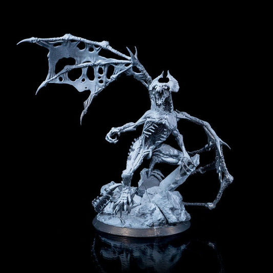 Front view of the Dracolich miniature, highlighting its skeletal structure, sharp claws, and gaping maw, with wings spread wide.