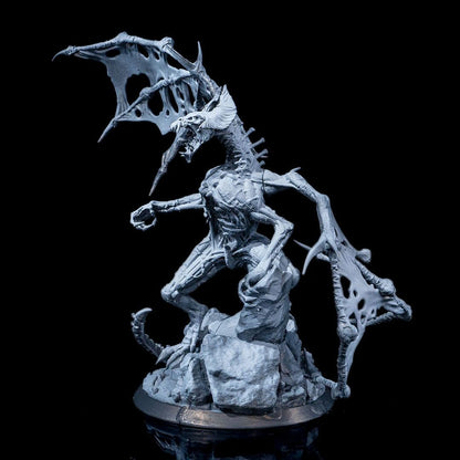 Dracolich miniature with a skeletal dragon form, decayed wings, and exposed ribs, standing on a rocky base with a menacing posture.